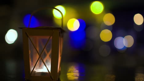 Outdoor-lantern-candle-inside-stirring-with-wind