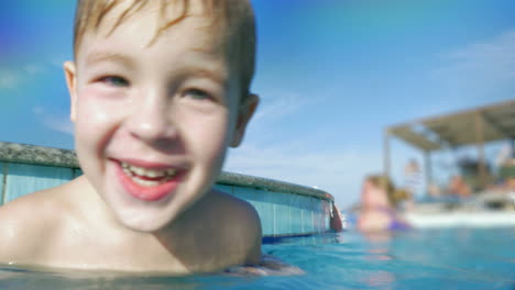 Happy-child-in-swimming-pool-splashing-water