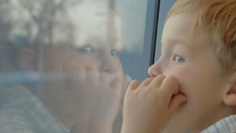Little-child-enjoying-view-from-the-train-window