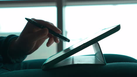 Woman-using-pen-to-work-with-touch-pad