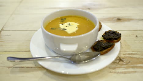 Serving-of-soup-with-bruschetta-in-cafe-or-restaurant