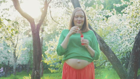 Pregnant-Woman-Blowing-Soap-Bubbles