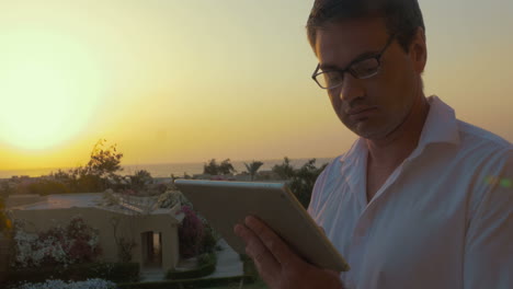 Man-with-Tablet-PC-at-Sunset