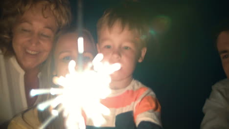 Parents-child-and-sparkler-at-night