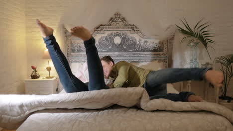 Happy-Couple-Jumping-on-the-Bed