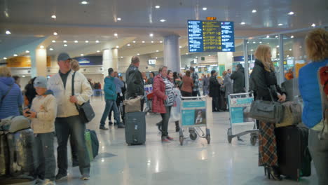 Passengers-with-luggage-waiting-at-the-airport