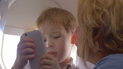 Grandmother-talking-to-grandson-in-the-plane