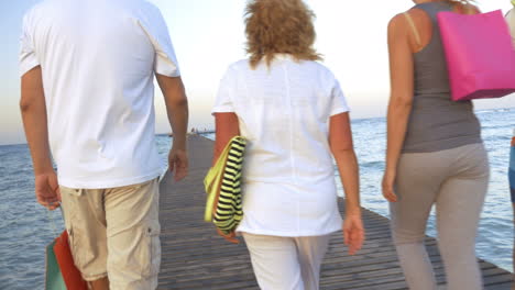 Family-with-shopping-bags-walking-on-the-pier