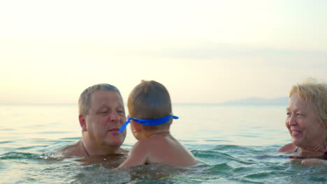 Grandparents-Teaching-Boy-Swimming-Underwater