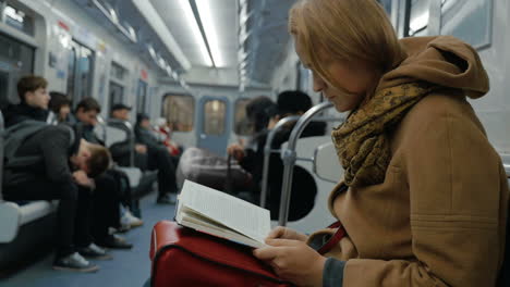 Young-woman-reading-a-book-in-subway