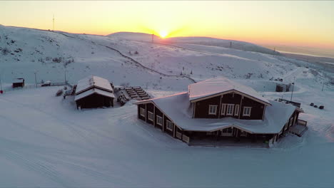 Flying-over-the-winter-ski-centre-at-sunset