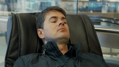 Man-having-a-rest-in-massage-chair