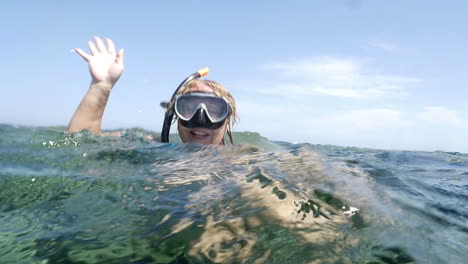 Woman-in-snorkel-sending-greeting-from-the-sea