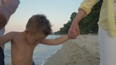 Child-with-grandparents-walking-on-the-shore