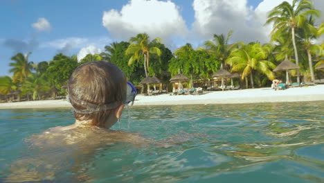 Slow-motion-view-of-small-boy-swimming-in-the-Indian-Ocean-in-the-snorkeling-mask-and-take-a-picture-Port-Louis-Mauritius-Island
