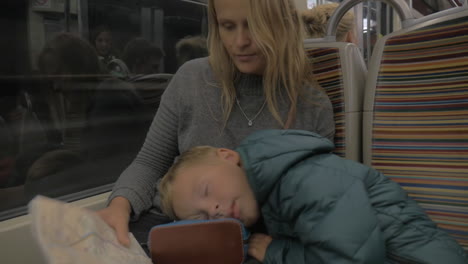 Mother-and-sleepy-child-in-underground-train