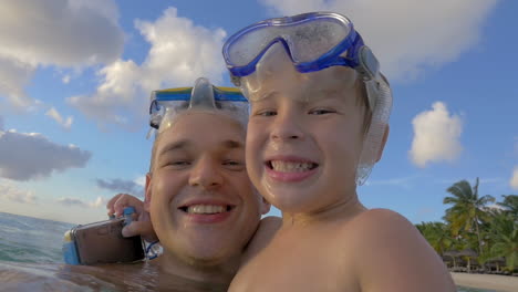 Smiling-father-and-son-bathing-in-the-sea
