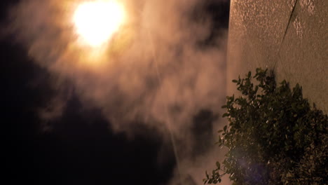 Street-lantern-and-condensing-smoke-spreading-outside-at-night