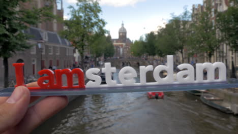 Amsterdam-slogan-and-city-view-with-canal