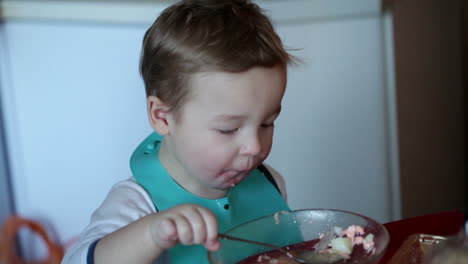 Two-year-old-boy-is-eating-soup-from-the-plate-Clip-one
