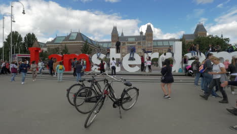 Tourists-making-photos-at-Amsterdam-slogan