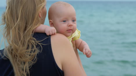 Mum-with-baby-daughter-enjoying-sea-and-breeze