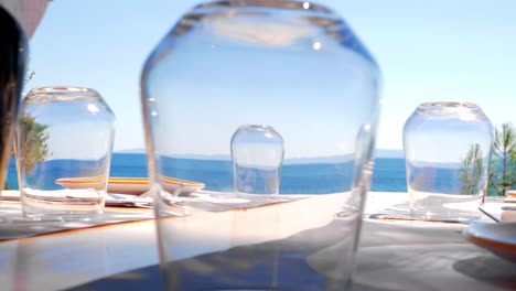 Looking-at-sea-through-the-glasses-on-cafe-table