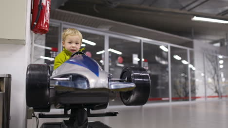 Little-boy-driving-a-racing-car