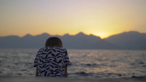 Lonely-child-on-the-beach-at-sunset