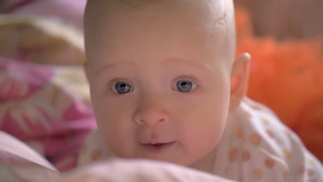 Portrait-of-baby-girl-with-big-blue-smiling-eyes