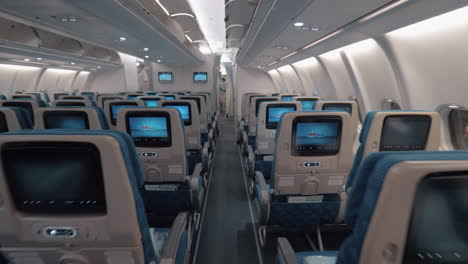 Airplane-cabin-with-aisle-and-empty-seats-of-economy-class