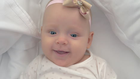 Portrait-of-smiling-blue-eyed-baby-girl-of-six-months-old