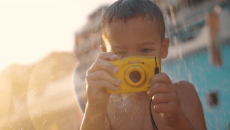Child-with-waterproof-camera-under-beach-shower