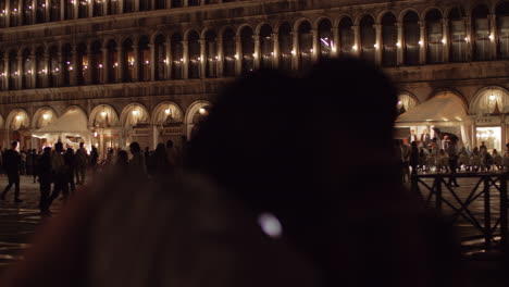 San-Marco-Square-at-night-and-tourists-taking-pictures-with-cells-Venice-Italy