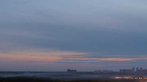 Scene-with-distant-high-rise-houses-and-fog-in-the-dusk