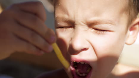 Kid-eating-fries-outdoor
