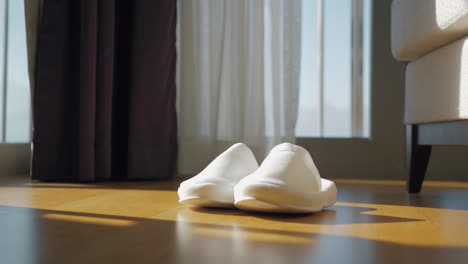 White-slippers-on-a-wooden-floor