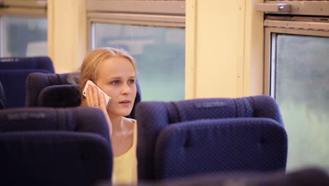 Woman-talking-on-the-phone-in-train