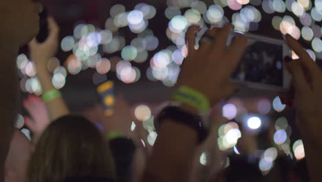 Audience-waving-with-cellphone-flashlights-at-the-concert