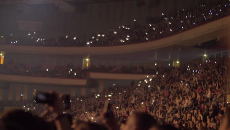 Audience-waving-hands-and-mobile-flashlights-at-the-concert