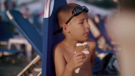 Child-eating-waffle-cone-ice-cream-at-the-beach