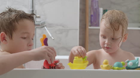Siblings-taking-a-bath-and-playing-with-toys