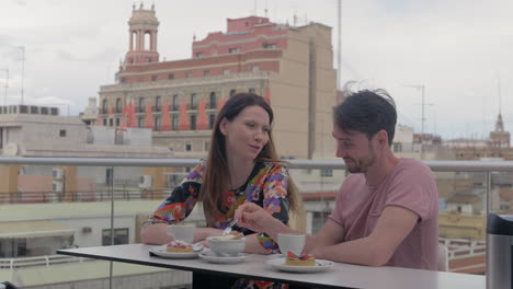 A-couple-enjoying-coffee-and-desserts-in-a-rooftop-cafe-in-Valencia