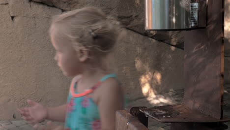 Little-girl-sanitizing-hands-outdoor