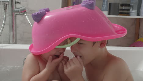 Playful-kids-trying-to-be-invisible-under-toy-bathtub