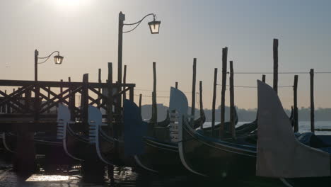 Scene-of-Venice-dock-with-gondolas-moored-near-the-pier