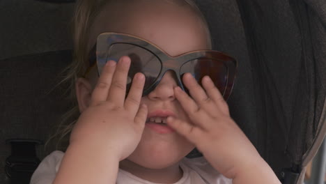 Lovely-baby-girl-in-mums-sunglasses