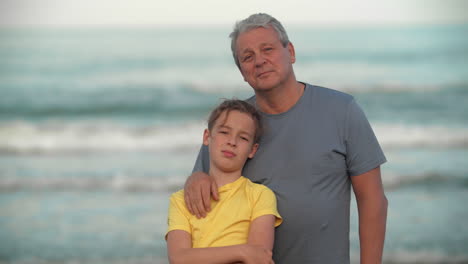Grandpa-with-teenage-grandchild-by-the-ocean