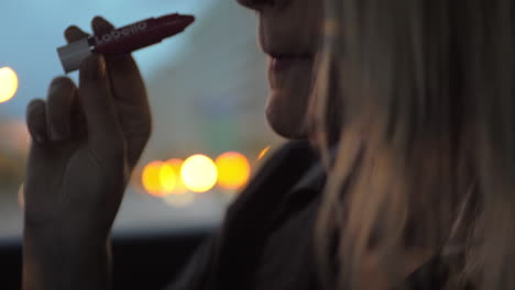 Woman-applying-Labello-lipstick-in-the-car