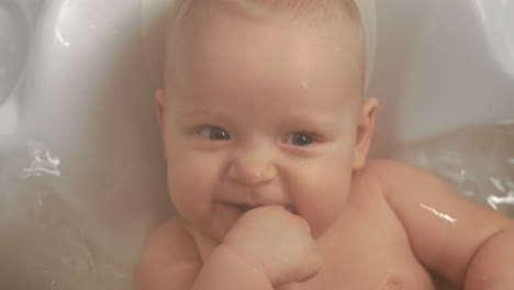 A-closeup-of-an-adorable-baby-girl-smiling-in-bathtub